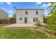 A backyard with a patio and a white two-story house under a blue sky at 8551 Belle Union Ct, Camby, IN 46113