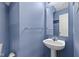 The half bath in this home features a blue paint, and pedestal sink at 8551 Belle Union Ct, Camby, IN 46113