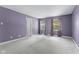 Bedroom with lilac-colored walls, two windows and a door painted white at 8551 Belle Union Ct, Camby, IN 46113