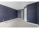 Spacious bedroom features light carpet and is painted a dark blue color at 8551 Belle Union Ct, Camby, IN 46113