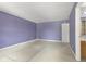 Bedroom with lilac-colored walls, beige carpet and a white door at 8551 Belle Union Ct, Camby, IN 46113