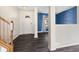 Inviting entryway with dark wood floors, a white front door, and stairs with wood railings at 8551 Belle Union Ct, Camby, IN 46113