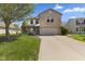 Charming two-story home featuring a brick facade, attached garage, and well-manicured lawn at 8551 Belle Union Ct, Camby, IN 46113