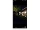 Nighttime view of front yard and house with professional outdoor lighting at 8551 Belle Union Ct, Camby, IN 46113