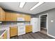 A full view of the kitchen, including the light wood cabinets, and a pantry in the corner at 8551 Belle Union Ct, Camby, IN 46113