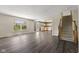 Open living room with dark wood floors leading to a kitchen and staircase at 8551 Belle Union Ct, Camby, IN 46113