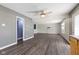 Open living room layout featuring dark wood floors and connecting to a kitchen area at 8551 Belle Union Ct, Camby, IN 46113