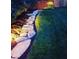 A stone pathway through a landscaped garden at night, softly lit at 8551 Belle Union Ct, Camby, IN 46113