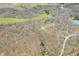Breathtaking aerial perspective of a vast wooded landscape with scattered homes and serene, reflective ponds at 8968 Old Haggard Rd, Morgantown, IN 46160