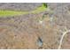 Picturesque aerial shot of a property nestled among dense trees, featuring small ponds and well-maintained structures at 8968 Old Haggard Rd, Morgantown, IN 46160