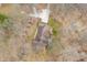 Aerial view of a cozy home with a large, welcoming patio surrounded by mature trees and a winding driveway at 8968 Old Haggard Rd, Morgantown, IN 46160