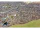 Aerial view of a property with a home, outbuildings, and a pond, bordered by vibrant green grass at 8968 Old Haggard Rd, Morgantown, IN 46160