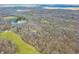 Wide aerial shot capturing a vast landscape featuring wooded areas, a lake, and distant land at 8968 Old Haggard Rd, Morgantown, IN 46160