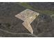 Aerial view of the property, highlighting land boundaries in a wooded area near a green meadow at 8968 Old Haggard Rd, Morgantown, IN 46160