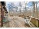 Expansive deck with outdoor seating areas and wooden railings overlooking the backyard and surrounding trees at 8968 Old Haggard Rd, Morgantown, IN 46160