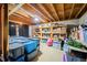 Unfinished basement with exposed ceiling and shelving, perfect for storage or customization to suit your needs at 8968 Old Haggard Rd, Morgantown, IN 46160