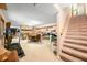 Finished basement with carpet, stairs, fireplace, dining table, office, and exercise machine at 8968 Old Haggard Rd, Morgantown, IN 46160
