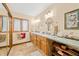 Bathroom features dual sinks with granite countertop and matching vanities, along with a window at 8968 Old Haggard Rd, Morgantown, IN 46160