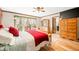 Bright bedroom with wooden floors, ceiling fan, and natural light flowing through the curtains at 8968 Old Haggard Rd, Morgantown, IN 46160