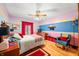 Comfortable bedroom featuring a ceiling fan, wooden floors, and a cozy chair at 8968 Old Haggard Rd, Morgantown, IN 46160