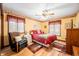 Bright bedroom with hardwood floors, a ceiling fan, and natural light from the windows at 8968 Old Haggard Rd, Morgantown, IN 46160