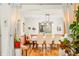 Bright dining room features hardwood floors, a long table with seating for eight, and a modern chandelier at 8968 Old Haggard Rd, Morgantown, IN 46160