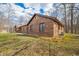 Brick home nestled among mature trees, offering privacy and a serene setting, with a shed on the left at 8968 Old Haggard Rd, Morgantown, IN 46160