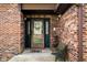 Inviting brick front entrance with decorative glass door and a bench at 8968 Old Haggard Rd, Morgantown, IN 46160