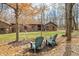 Inviting front yard with lush landscaping and cozy chairs offering an appealing outdoor retreat at 8968 Old Haggard Rd, Morgantown, IN 46160