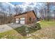 Home's brick exterior featuring a two-car garage, and a walkway at 8968 Old Haggard Rd, Morgantown, IN 46160