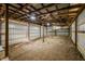 Outbuilding interior featuring metal walls, wood beams, gravel floor and ample natural light at 8968 Old Haggard Rd, Morgantown, IN 46160