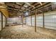 Spacious interior of outbuilding with metal walls, wooden beams and a gravel floor at 8968 Old Haggard Rd, Morgantown, IN 46160