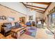 Bright living room with vaulted ceilings, wood beams, and fireplace at 8968 Old Haggard Rd, Morgantown, IN 46160