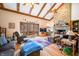 Bright living room with exposed beams, stone fireplace, and view of a private deck at 8968 Old Haggard Rd, Morgantown, IN 46160