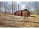 Exterior shot of outbuilding featuring a metal frame and sliding doors surrounded by trees at 8968 Old Haggard Rd, Morgantown, IN 46160