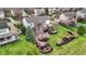 This overhead view shows a backyard with firepit and lounge area, mature landscaping and home exterior at 9253 Windrift Way, Zionsville, IN 46077