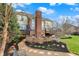 Beautiful backyard featuring a patio area, fire pit, lush landscaping, and a well-maintained lawn at 9253 Windrift Way, Zionsville, IN 46077