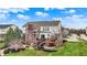 An expansive backyard features a deck, comfortable seating, a lush lawn, and mature trees, perfect for outdoor activities at 9253 Windrift Way, Zionsville, IN 46077
