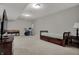 Brightly lit basement area with music equipment, bed, and entertainment space for leisure and recreation at 9253 Windrift Way, Zionsville, IN 46077