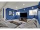 Cozy finished basement with a large gray sectional, flat-screen TV, and stylish decor at 9253 Windrift Way, Zionsville, IN 46077