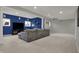 Spacious finished basement with plush carpeting, a large gray sofa, and natural light from the windows at 9253 Windrift Way, Zionsville, IN 46077