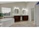 Bright bathroom features a soaking tub, dual sinks, and ample counter space and natural light at 9253 Windrift Way, Zionsville, IN 46077