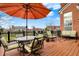 Outdoor deck area with seating and an umbrella, perfect for relaxing and entertaining guests at 9253 Windrift Way, Zionsville, IN 46077