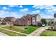 Picture of a brick home with an attached garage, driveway, manicured lawns, and mature trees at 9253 Windrift Way, Zionsville, IN 46077