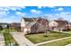 Beautiful home exterior showcasing manicured lawn, mature landscaping, and a spacious driveway at 9253 Windrift Way, Zionsville, IN 46077