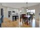 Eat-in kitchen with island, white cabinets, stainless steel appliances, and hardwood floors at 9253 Windrift Way, Zionsville, IN 46077