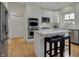 Well-lit kitchen with stainless steel appliances, a kitchen island, and hardwood floors at 9253 Windrift Way, Zionsville, IN 46077