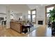 Bright living room showcases hardwood floors, open access to the kitchen, and a fireplace at 9253 Windrift Way, Zionsville, IN 46077