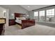Spacious main bedroom with large windows, a comfortable bed, and neutral color palette at 9253 Windrift Way, Zionsville, IN 46077