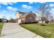 Charming home featuring a brick exterior, attached garage, well-maintained lawn, and neat landscaping at 9253 Windrift Way, Zionsville, IN 46077